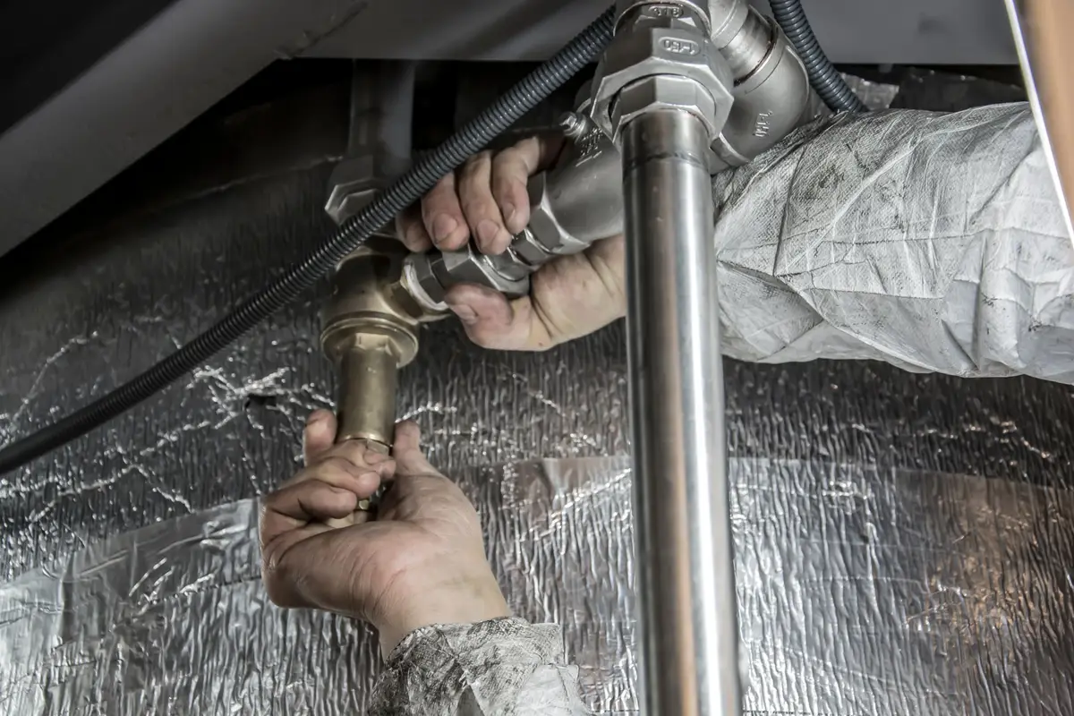 Plumber installing pipe in a home in Kyle, TX